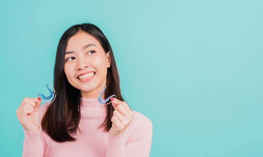 Girl Holding invisalign